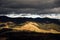 Golden autumn in the Carpathians. Mining arrays combined with trees with yellow leaves. Beautiful clouds and sun