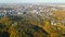 Golden autumn Kyiv cityscape, aerial drone view of city skyline and forest with yellow trees and beautiful landscape from above