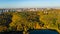 Golden autumn Kyiv cityscape, aerial drone view of city skyline and forest with yellow trees and beautiful landscape from above