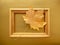 Golden autumn. Maple leaf framed on a gold paper background