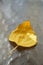 Golden autumnal birch leaf on a sunny glass table