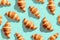 Golden Baked Croissants on Blue Background for Culinary Concepts