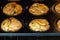 Golden baked vegan vanilla cherry muffins in an oven - close-up