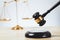 Golden balanced scale and gavel on desk with book in law office. equility