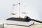 Golden balanced scale and gavel on desk with book in law office. equility