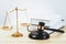 Golden balanced scale and gavel on desk with book in law office. equility