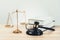 Golden balanced scale and gavel on desk with book in law office. equility