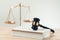 Golden balanced scale and gavel on desk with book in law office. equility