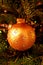 Golden ball decoration on Xmas tree. Beautiful xmas ornament.