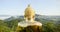 Golden Big buddha green hill mist on mountain range in morning. Panning Buddhist religion temple hill back view giant big buddha w