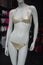 golden bikini on mannequin in fashion store showroom for women