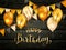 Golden Birthday Balloons and Pennants on Black Wooden Background