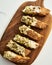 Golden Biscotti or Cantuccini on white plate on the white marble background.Traditional Sweet Italian cookies, two times