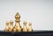 The golden bishop chess piece in front gold pawns on white background.