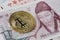 Golden bitcoin on 1000 South Korean won currency with copy space