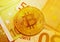 Golden bitcoin on 50 and 100 Euro banknotes background, cryptocurrency financial concept of global economic crisis. Modern income
