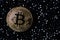 Golden bitcoin on a black jewels. Gold coin of cryptocurrency.
