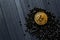 Golden bitcoin on a black jewels. Gold coin of cryptocurrency.