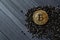 Golden bitcoin on a black jewels. Gold coin of cryptocurrency.