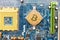 Golden Bitcoin on the circuit main computer board. Digital currency generation concept