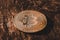 Golden bitcoin coin on a dark hard wooden surface. World cryptocurrency