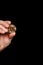 Golden Bitcoin coin in hands on black background. Crypto investor is holding gold bitcoin close-up.