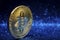 Golden bitcoin coin with sparkle blue background, crypto currency concept.