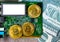 Golden bitcoin and computer chip. Concept of Bitcoin Mining. Golden Bitcoin on the green microchip board with dollars
