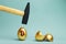 Golden bitcoin egg and hammer hovering over it, before the hit. Broken bitcoin egg. Collapse of bitcoin, the loss of money concept