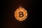 Golden bitcoin with flame and smoke isolated on black background