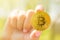 Golden bitcoin in generation alpha kids hand, uncertainty future life with bitcoin in hand