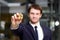 Golden Bitcoin in hand with businessman blurred on background