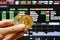 Golden Bitcoin hand on front of stock screen, a digital cryptocurrency that represent decentralized digital currency without a