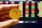 Golden Bitcoin hand on front of stock screen, a digital cryptocurrency that represent decentralized digital currency without a