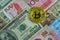 Golden bitcoin on international banknote, bitcoin electronic mon