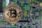 Golden bitcoin on the motherboard, selective focus