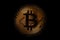 Golden Bitcoin over dark background. Business and virtual cryptocurrency concept.