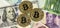 Golden bitcoin over multi currency banknotes dollar, yuan, euro