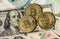 Golden bitcoin over multi currency banknotes dollar, yuan, euro