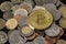 Golden bitcoin over a pile of coins.