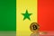 Golden bitcoin stands on a background of state flag of Senegal