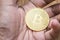 Golden bitcoin in the stock market investor hand for the digital money