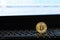 Golden bitcoin token on black computer keyboard