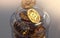 Golden Bitcoins in a jar. Storing cryptocurrencies concept. Realistic 3D rendering