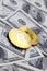 Golden bitcoins lie on a lot of dollar bills. The concept of raising the price of bitcoin relative to the US dolla