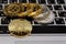 Golden bitcoins lies on silver notebook keyboard