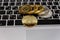 Golden bitcoins lies on silver notebook keyboard