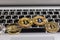 Golden bitcoins lies on silver notebook keyboard