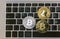 Golden bitcoins lies on silver notebook keyboard