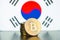 Golden bitcoins and South Korea flag.